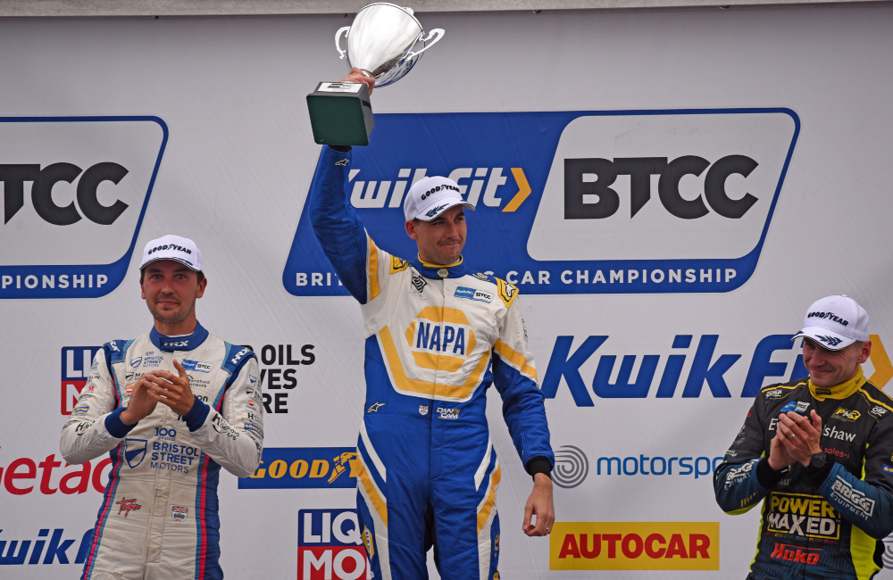 Dan Cammish celebrates on the podium with a trophy